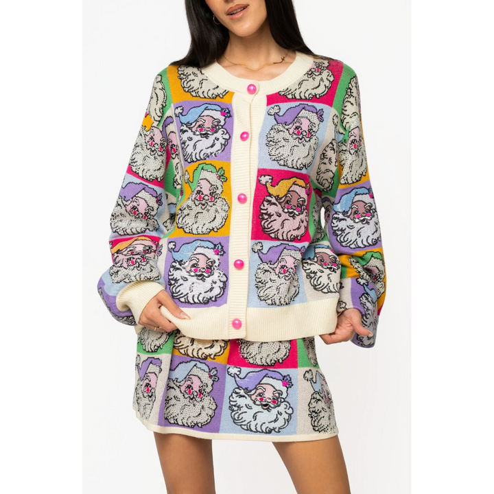 Model wearing the vibrant Queen of Sparkles pastel colorblock Santa button-up holiday cardigan.