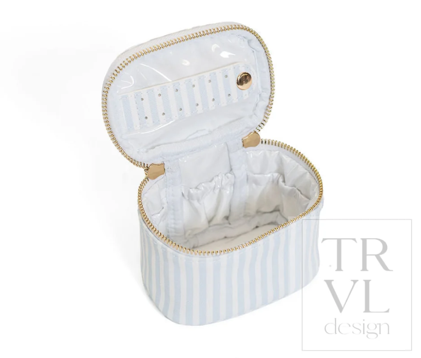 Inside view of the TRVL Design travel jewelry box showing the chambray lining, elasticized compartments, and earring bar.