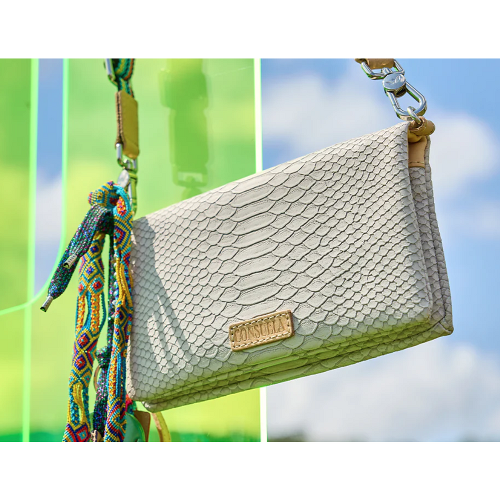 Consuela Thunderbird Uptown Crossbody bag featuring colorful patterns, a detachable wristlet, and natural leather trim.