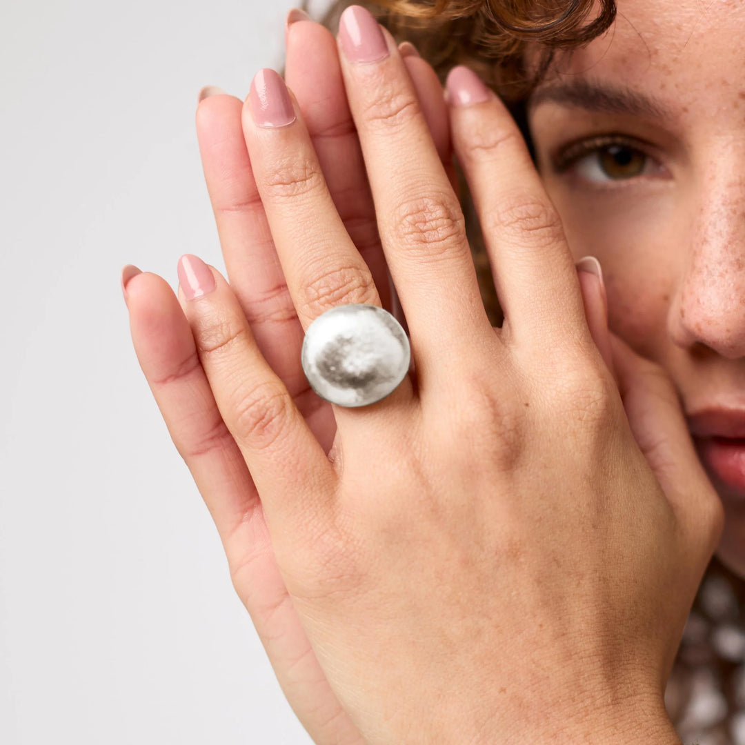 The Solara Hammered Ring styled on a hand, showing its sculptural silhouette and comfortable fit.