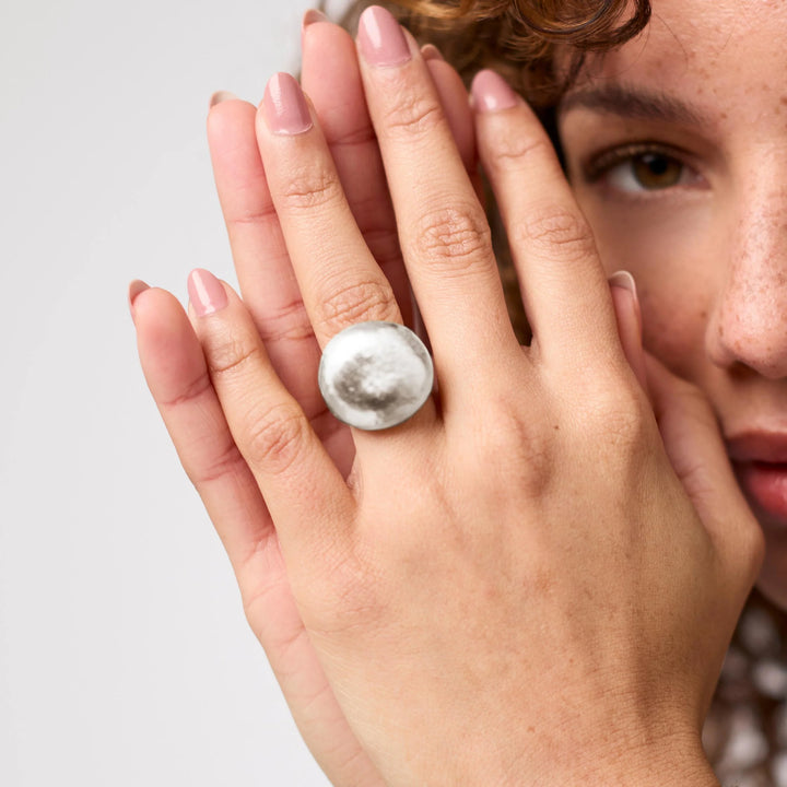 The Solara Hammered Ring styled on a hand, showing its sculptural silhouette and comfortable fit.