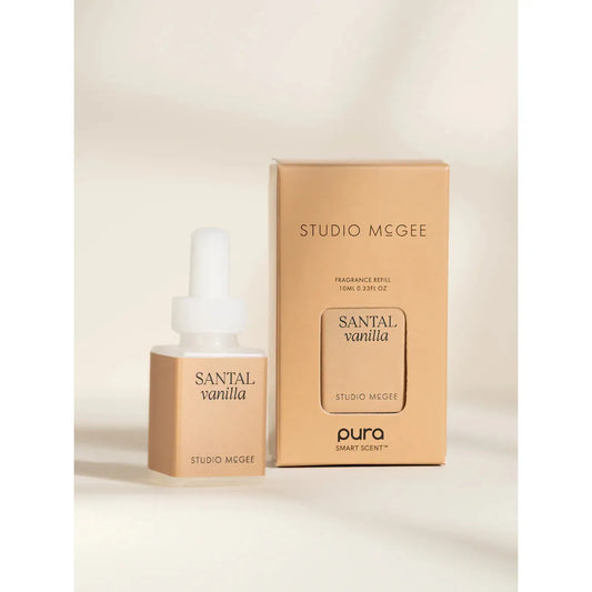 Pura smart fragrance vial in Santal Vanilla, featuring a minimalist label with woodsy and vanilla-inspired sketches.