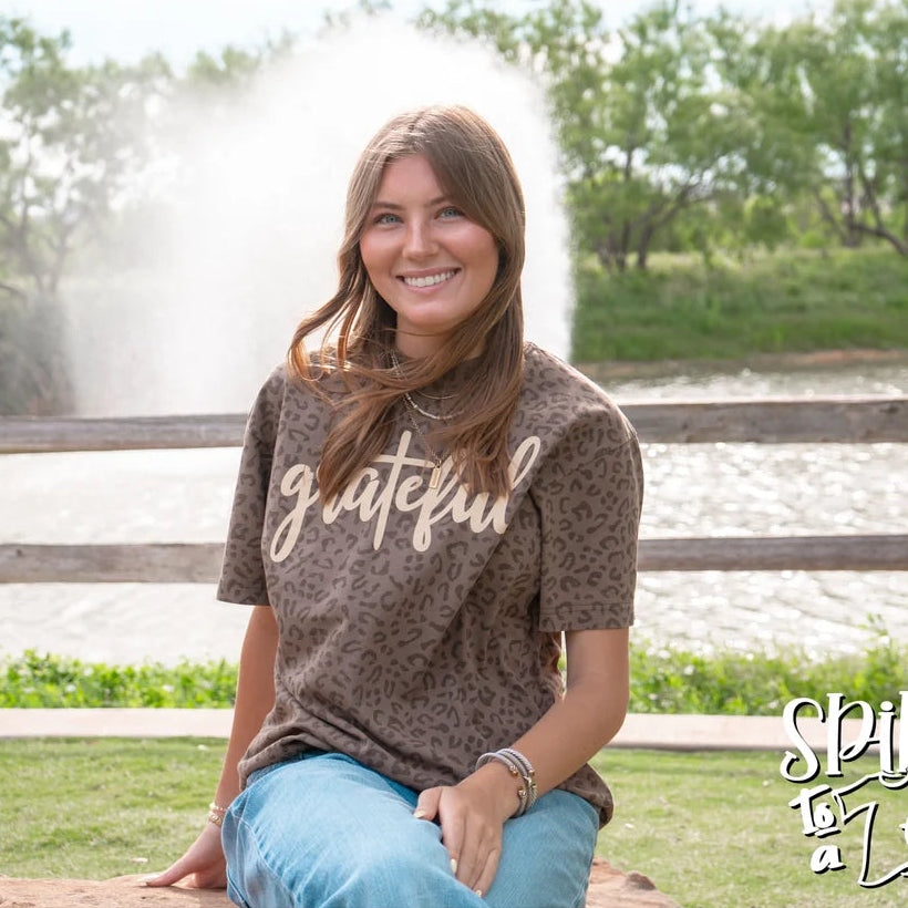 Close-up of the Spirit to a Tee Grateful brown animal print drop-shoulder graphic tee.