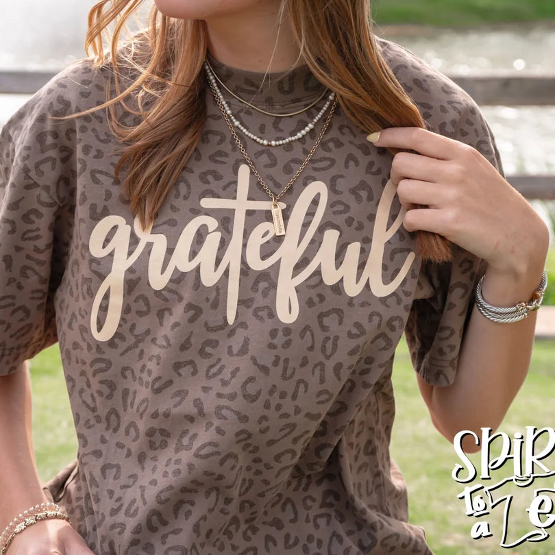 Close-up of the Spirit to a Tee Grateful brown animal print drop-shoulder graphic tee.