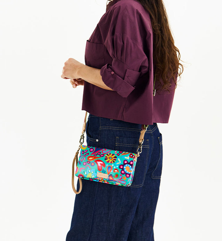 Consuela Tasha Uptown Crossbody bag featuring a colorful floral ConsuelaCloth exterior.