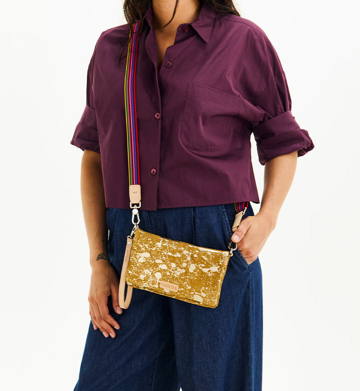 Consuela Marlow Uptown Crossbody bag featuring a metallic hand-splattered leather suede exterior.