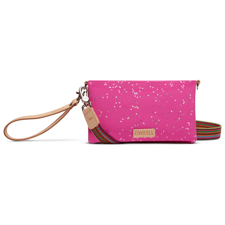Consuela Berry Uptown Crossbody in berry-pink with silver star print, tan leather wristlet, and rainbow woven crossbody strap