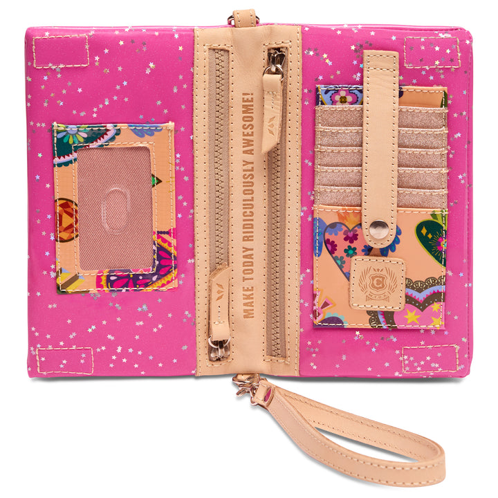 Interior of the Consuela Berry Uptown crossbody with pink stars-and-floral lining, card slots, a clear ID window, and zip pockets