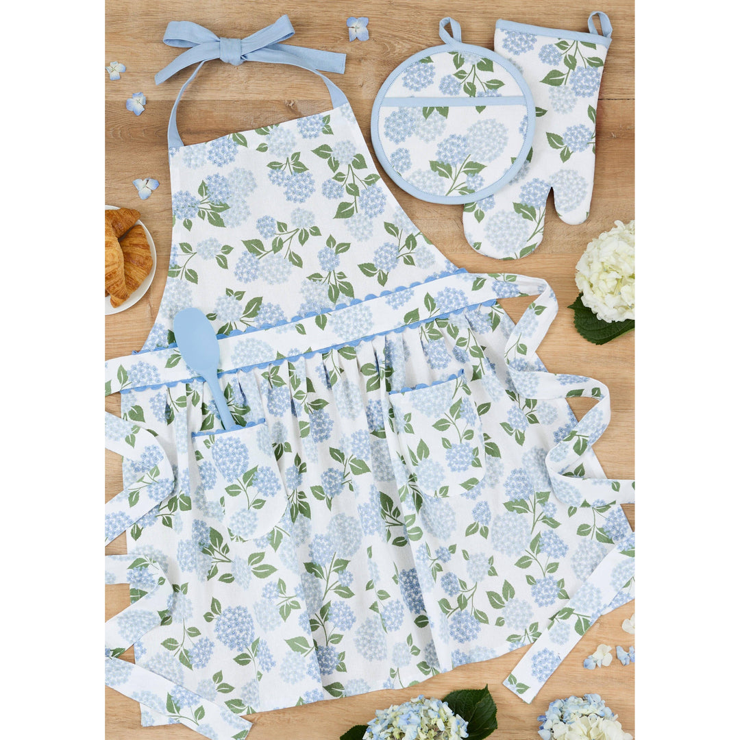 Folded Hydrangea Garden apron paired with matching floral tea towels, tied with a ribbon as a kitchen gift set.