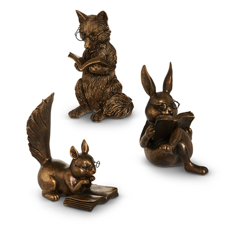 Three bronze animal figurines: a fox, a rabbit, and a squirrel, each reading a book on a white background.
