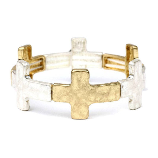 Two gold and silver cross-shaped rings on a white background
