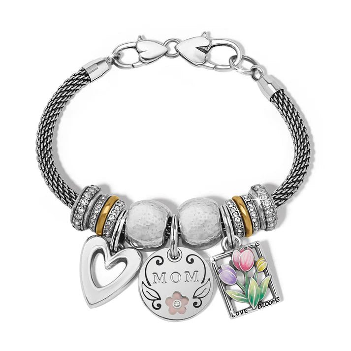 Close-up of the polished silver finish on the Cascade heart charm, showing its fluid, aerodynamic lines.