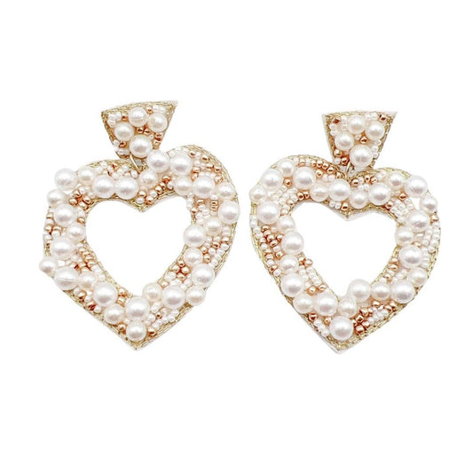 Heart-shaped earrings with pearl detailing on a white background