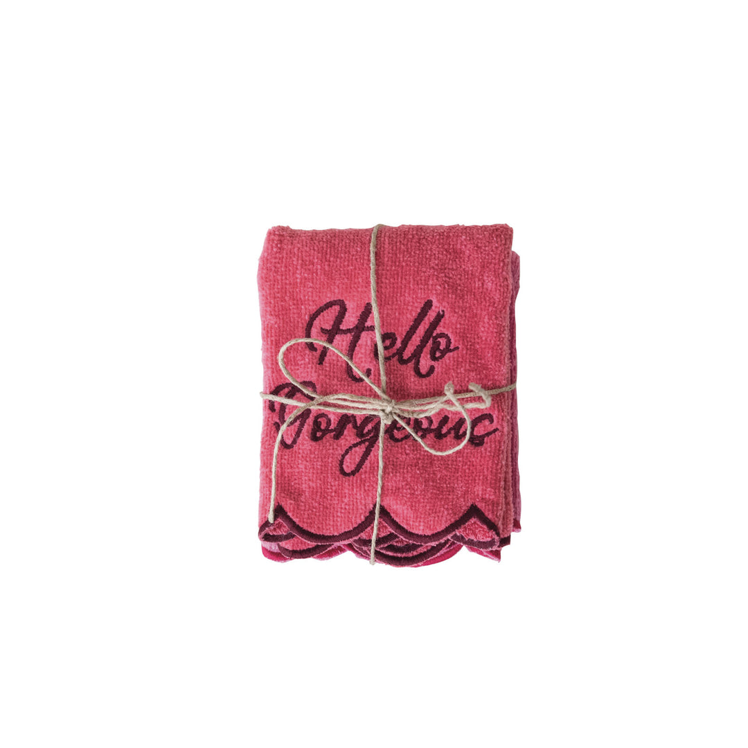 Pair of pink cotton wash cloths with scalloped dark pink edges and "Hello Gorgeous" embroidered text.