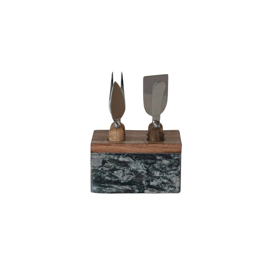 Creative Co-Op 5-piece stainless steel cheese server set with mango wood handles and a white marble display stand.