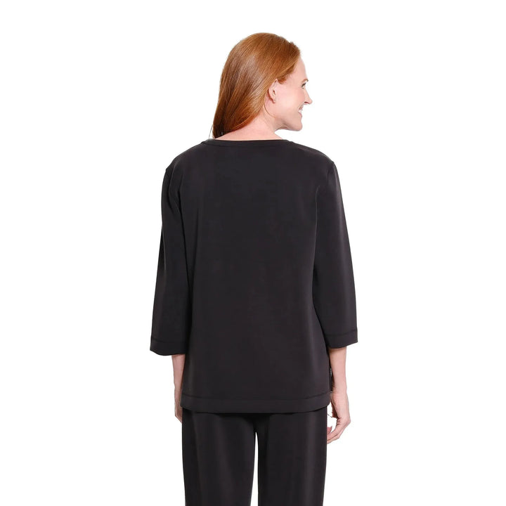 Multiples two-piece black knit set featuring a drop shoulder hi-low top and wide-leg ankle pants.