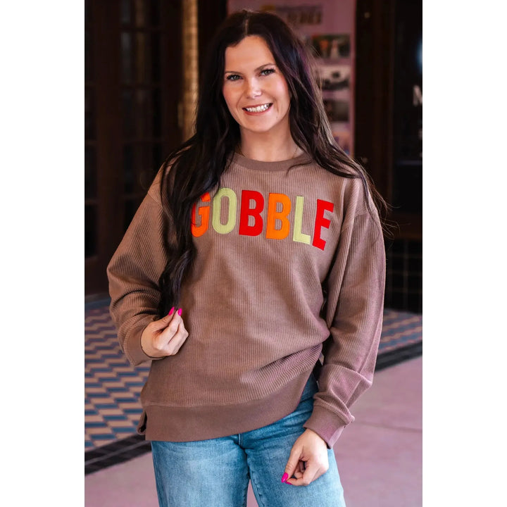 Spirit to a Tee brown cozycord crewneck sweatshirt featuring the word "Gobble" in textured tackle twill lettering.