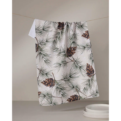 Towel with pine cone and branch pattern hanging on a line