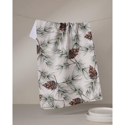 Towel with pine cone and branch pattern hanging on a line