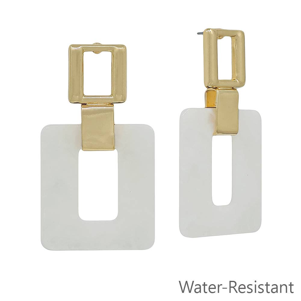 Gold and white square earrings on a white background