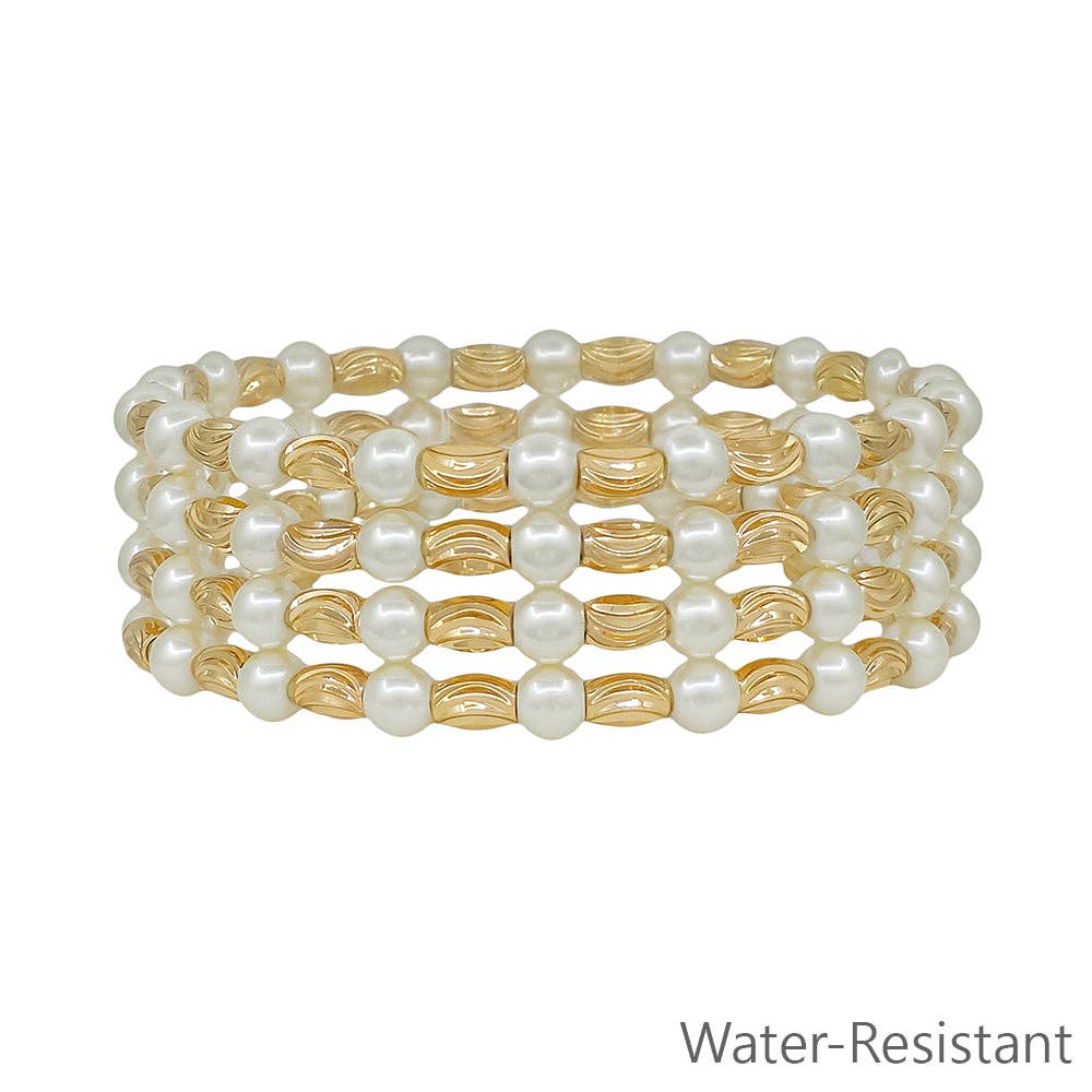 Set of pearl and gold beaded bracelets on a white background with &