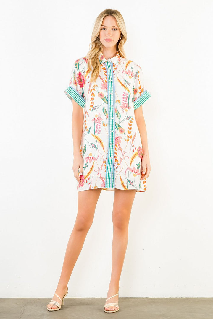 Woman modeling the THML Floral Print Collared Dress featuring a vibrant floral pattern, short sleeves, and a chic collared neckline.