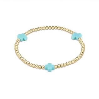 An enewton eGirl Signature Cross 3mm gold bead bracelet featuring three vibrant turquoise cross accents evenly spaced along a 14kt gold-filled stretch strand.