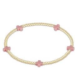 An enewton Signature Cross small 2mm gold bead bracelet featuring pastel pink accents and 14kt gold-filled beads on a stretch elastic cord.