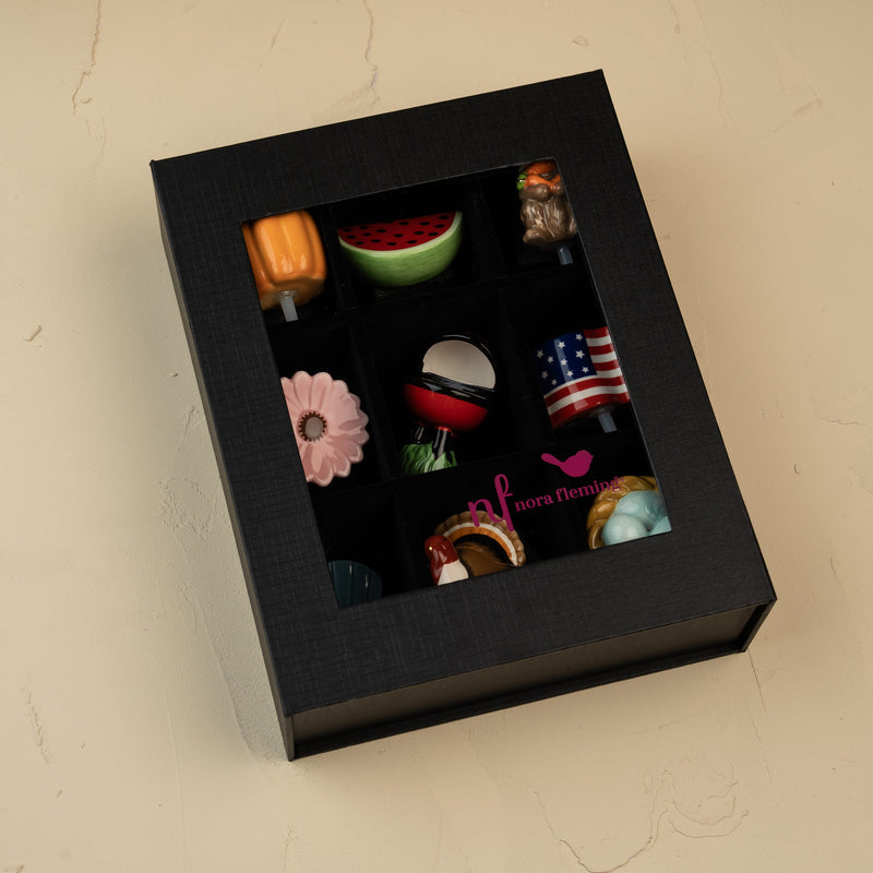 Close-up of the Nora Fleming keepsake box featuring an acrylic viewing window and magnetic closure.