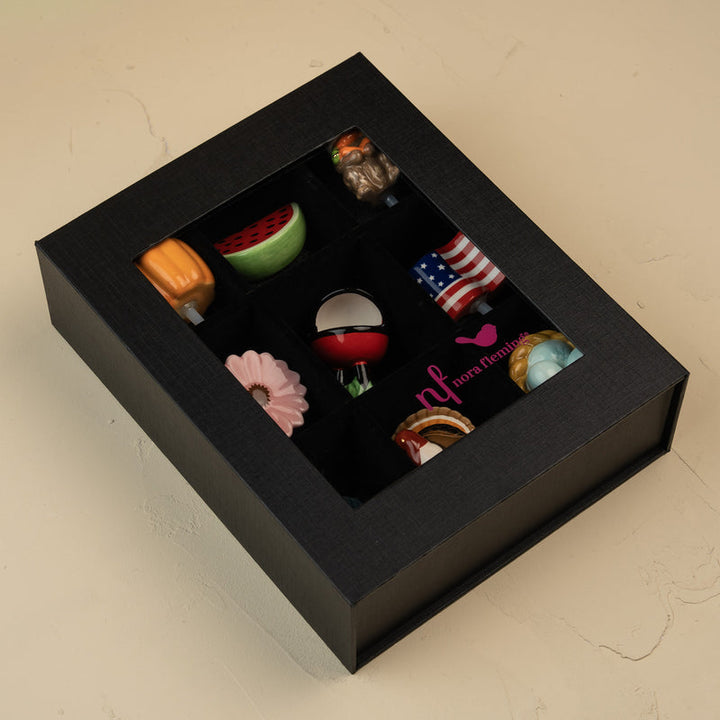 Nora Fleming 9-piece keepsake box filled with a colorful collection of decorative minis.