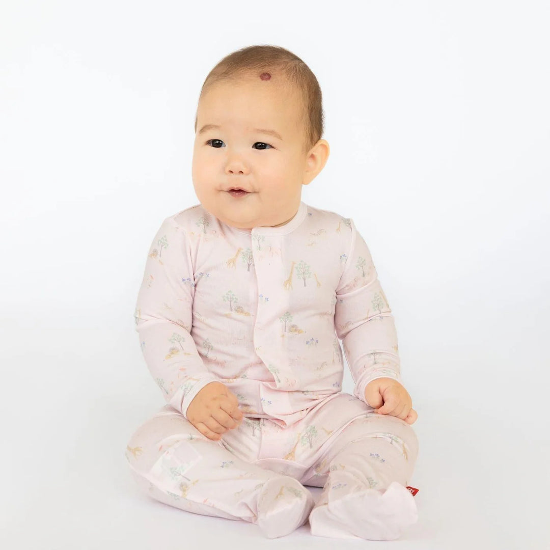 Magnetic Me Pink Serene Safari Modal Magnetic Footie featuring a pink animal print with lions and giraffes.