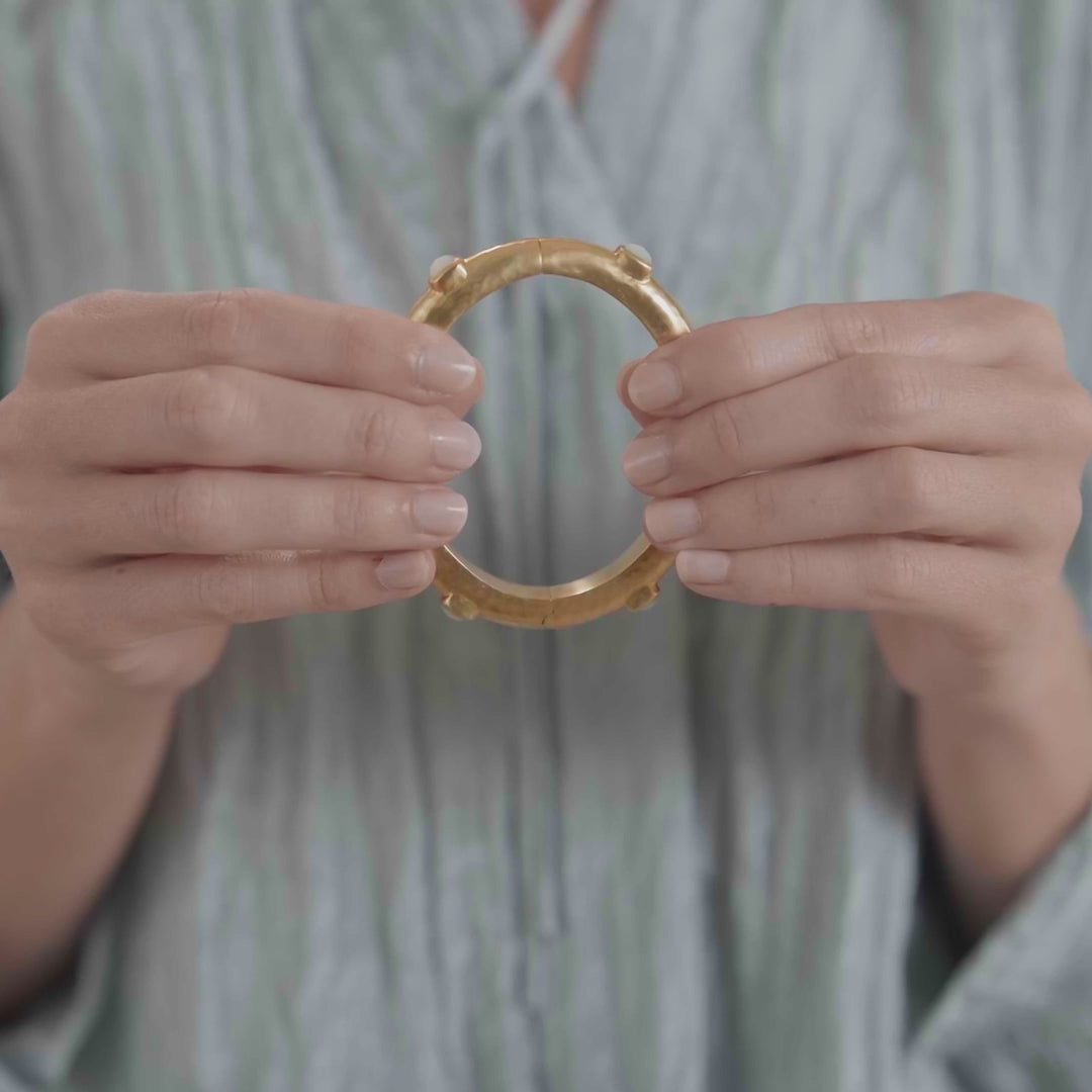 Julie Vos Catalina Hinge Bangle in 24K gold plate, featuring a lightly hammered finish and mother of pearl doublet stations.