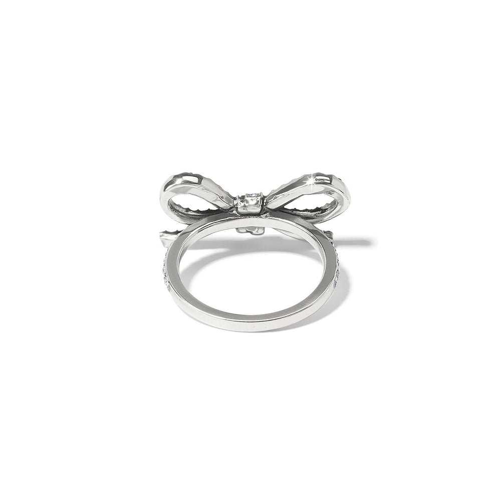 Close-up of the Illumina Bow Ring showing the intricate crystal settings and silver finish. 