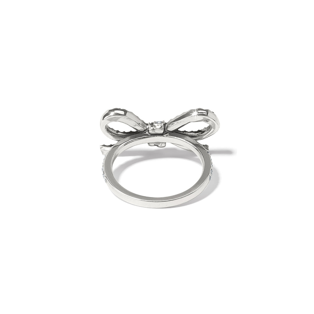 Close-up of the Illumina Bow Ring showing the intricate crystal settings and silver finish. 