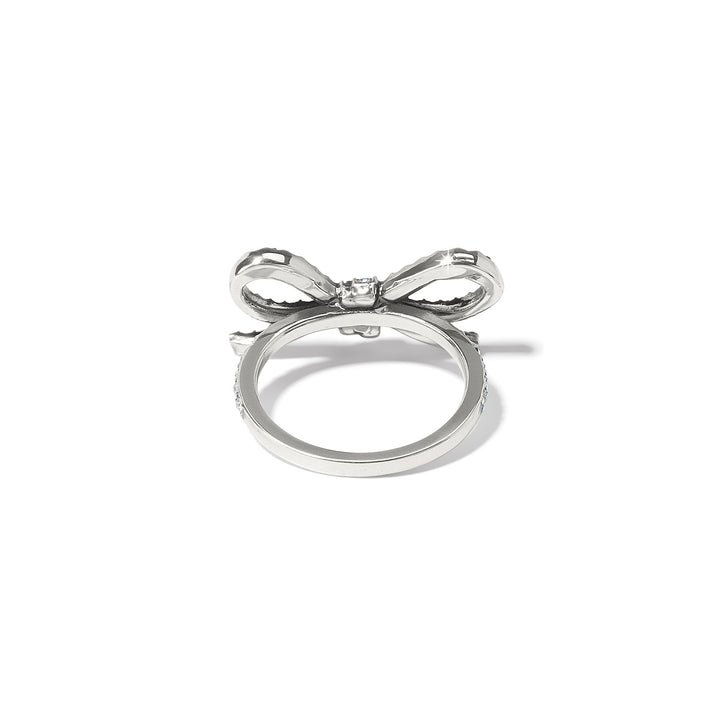 Close-up of the Illumina Bow Ring showing the intricate crystal settings and silver finish. 