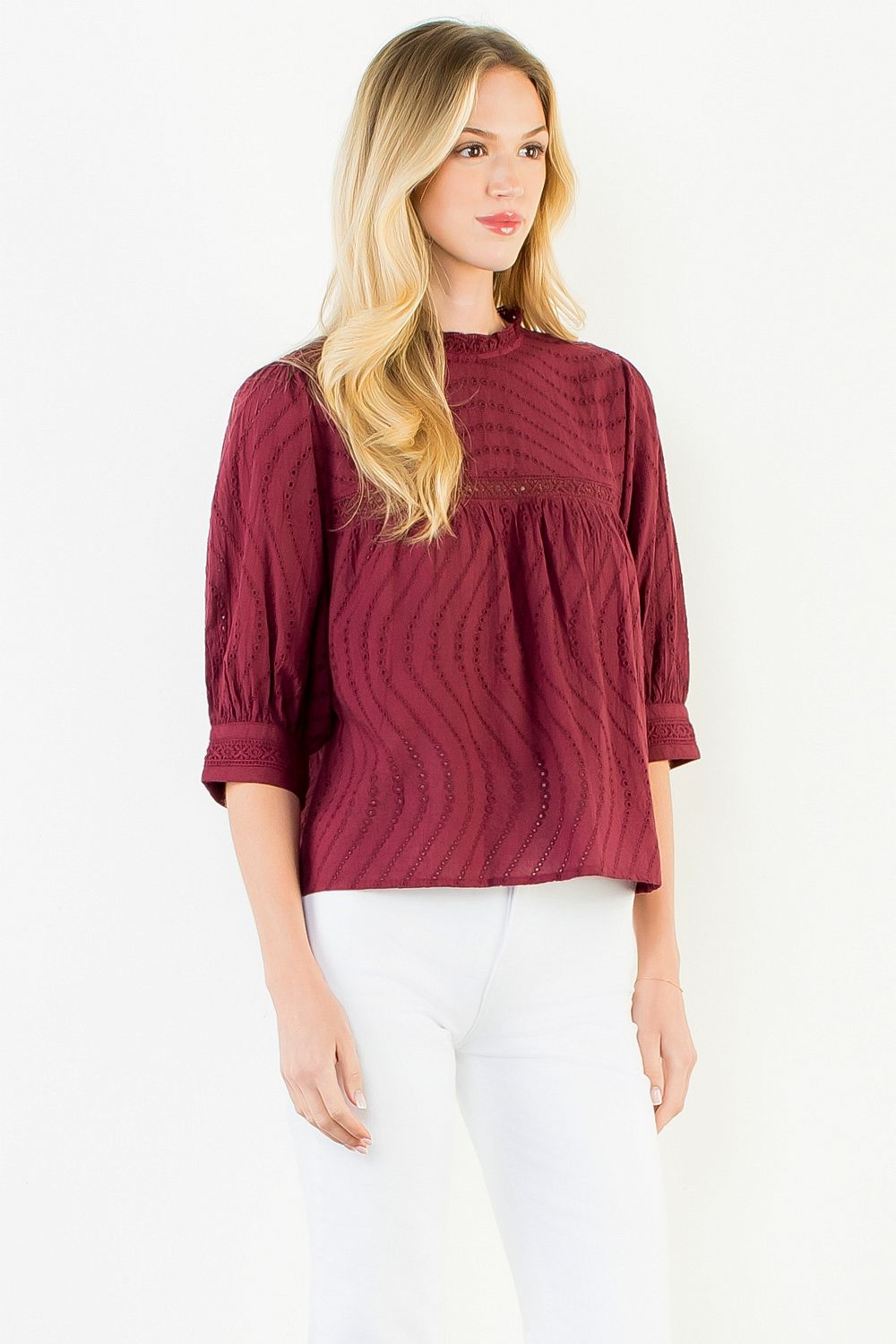 Model wearing the THML Flowy Cut Out Top in Burgundy featuring a flattering neckline detail.