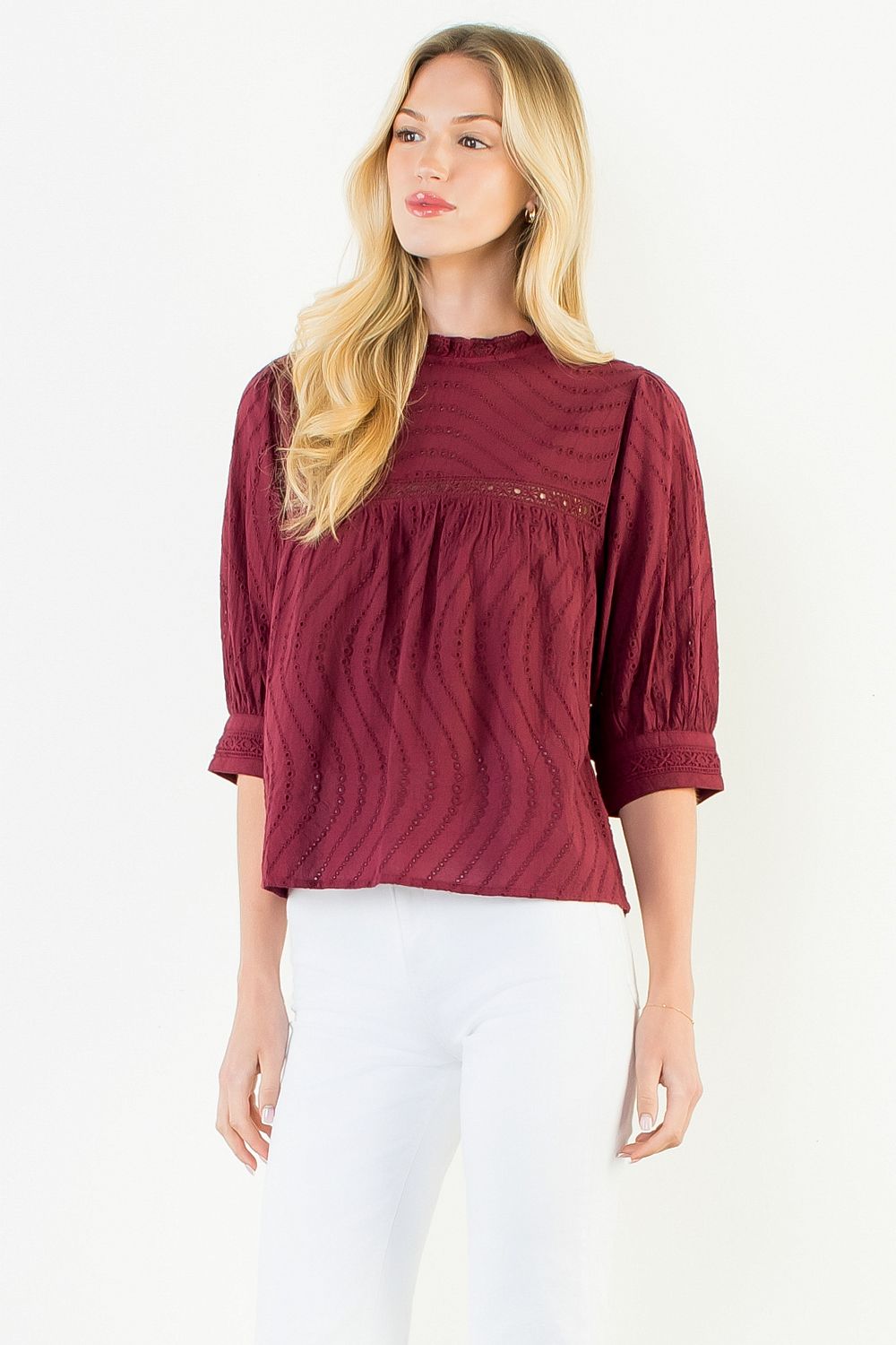 Model wearing the THML Flowy Cut Out Top in Burgundy featuring a flattering neckline detail.