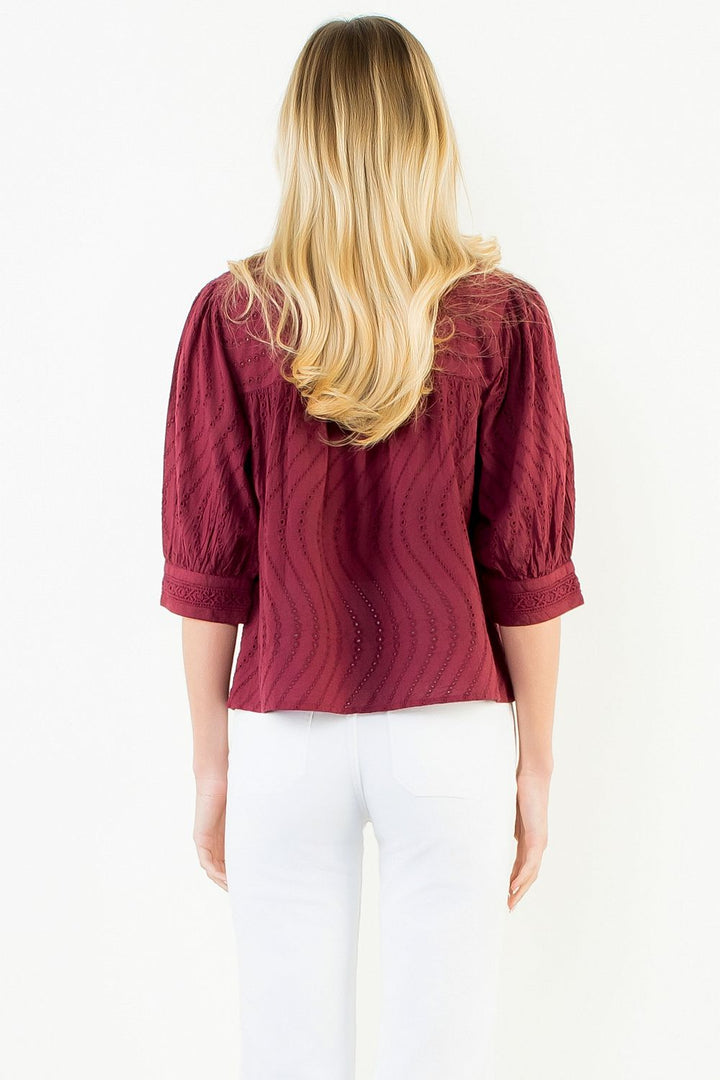 Model wearing the THML Flowy Cut Out Top in Burgundy featuring a flattering neckline detail.