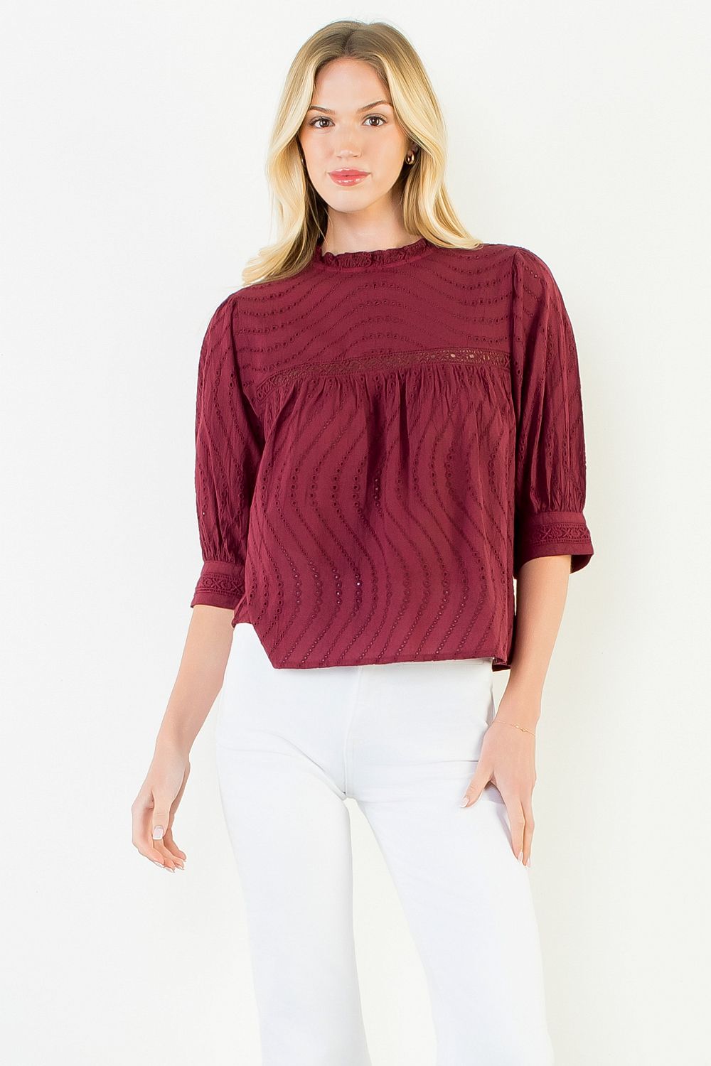 Model wearing the THML Flowy Cut Out Top in Burgundy featuring a flattering neckline detail.