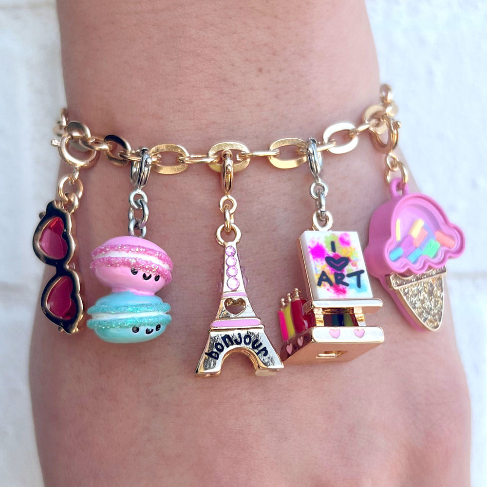 Charm It Macaron Buddies charm styled with Paris and sunglasses charms on a girls bracelet