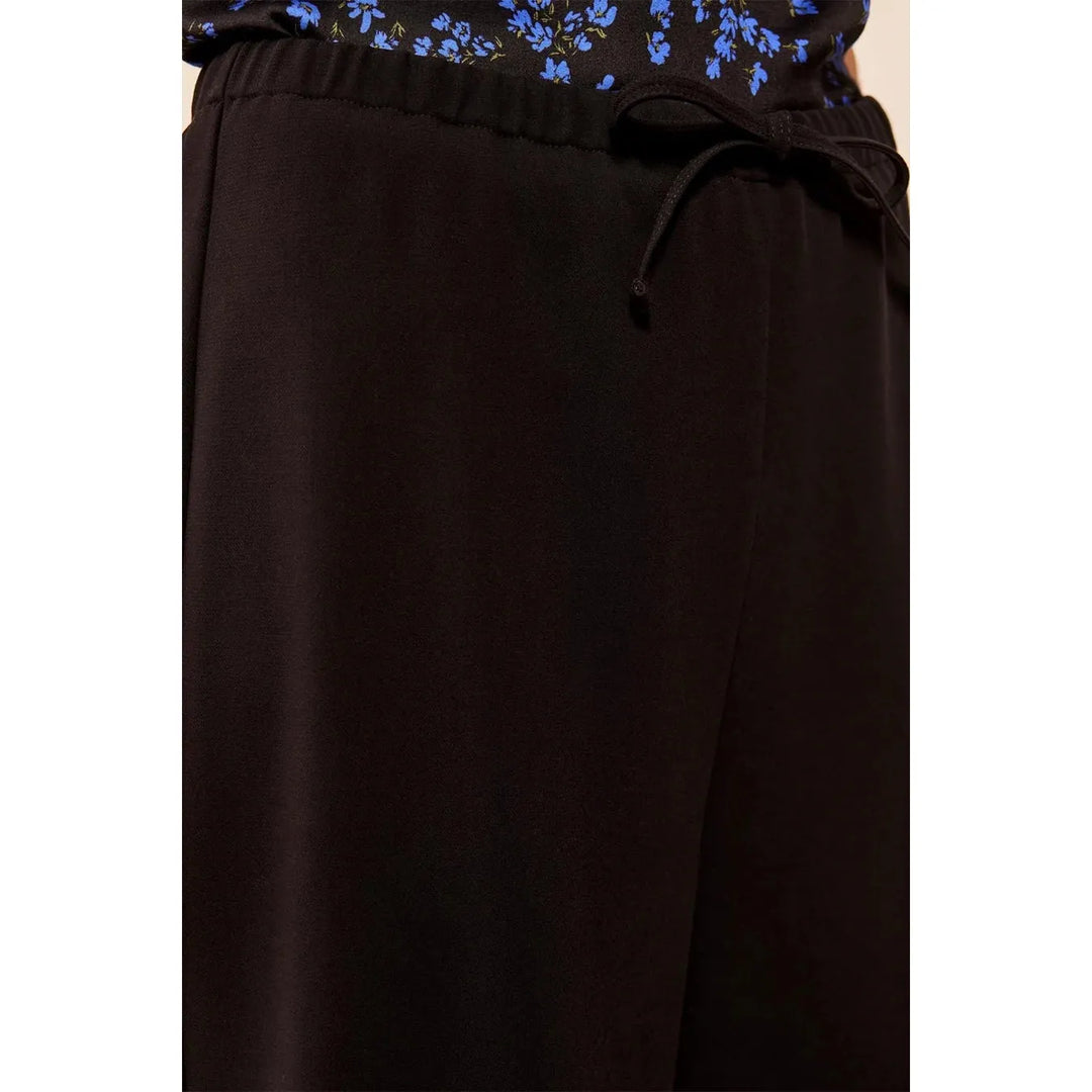 Close-up of the elasticized waistband and functional drawcord on the Tribal black pants.