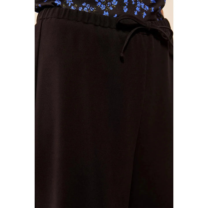 Close-up of the elasticized waistband and functional drawcord on the Tribal black pants.