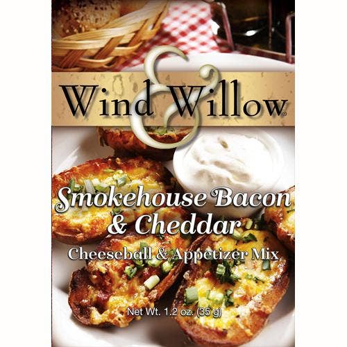 Wind & Willow Smokehouse Bacon and Cheddar Cheeseball on a platter with crackers and a side of fresh grapes.
