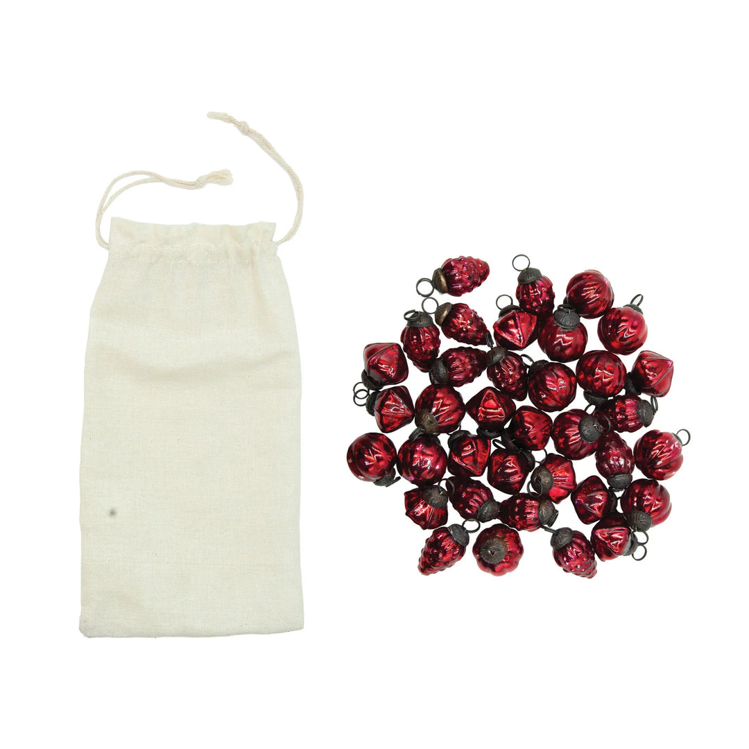 Creative Co-op set of 36 one-inch embossed red mercury glass mini ornaments displayed with their muslin drawstring bag